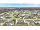 An aerial view captures a scenic community with a pond and tree-lined streets, highlighting a tranquil environment at 10237 Sand Run Ln, Fortville, IN 46040