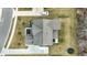 Detailed aerial view of a home and its surrounding yard, highlighting the driveway and landscaping at 10237 Sand Run Ln, Fortville, IN 46040