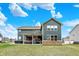 Large backyard with a covered patio, hot tub, and well-maintained lawn at 10237 Sand Run Ln, Fortville, IN 46040