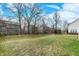 A spacious backyard with trees and a trampoline, perfect for outdoor activities at 10237 Sand Run Ln, Fortville, IN 46040