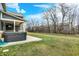 Backyard area featuring a hot tub and outdoor seating with trees in the background at 10237 Sand Run Ln, Fortville, IN 46040