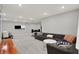 Expansive basement features neutral carpet, a large sofa, and ample space for entertaining at 10237 Sand Run Ln, Fortville, IN 46040
