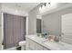 Bright bathroom features a double vanity with modern fixtures and a shower with a stylish curtain at 10237 Sand Run Ln, Fortville, IN 46040