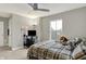 Cozy bedroom features a unique ceiling fan, well-lit desk area and comfortable decor at 10237 Sand Run Ln, Fortville, IN 46040