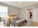 This comfortable bedroom features neutral walls, soft carpet, and a glimpse into a walk-in closet, creating a serene atmosphere at 10237 Sand Run Ln, Fortville, IN 46040