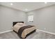 Clean, minimalist bedroom with a comfortable bed, window, and soft gray walls, offering a serene retreat at 10237 Sand Run Ln, Fortville, IN 46040