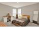 A cozy bedroom features a comfortable bed, vanity desk, and large mirror, creating a relaxing and stylish retreat at 10237 Sand Run Ln, Fortville, IN 46040
