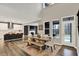 Bright dining area with wooden table, bench seating, and a view into the modern kitchen, creating an open and inviting space at 10237 Sand Run Ln, Fortville, IN 46040