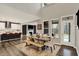 Open dining room with large windows, a view of the kitchen, and a seamless flow into the living area at 10237 Sand Run Ln, Fortville, IN 46040