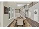 Dining room with a view of the staircase, table setting, and a decorative wreath on the door at 10237 Sand Run Ln, Fortville, IN 46040