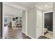 Open entryway with grey walls, white trim, and dark laminate flooring leading to the dining and living rooms at 10237 Sand Run Ln, Fortville, IN 46040