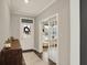 Inviting entryway with hardwood floors, a decorative rug, and a view into a bright office space at 10237 Sand Run Ln, Fortville, IN 46040