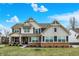 Inviting two-story home featuring a brick-accented facade, charming shutters, and a well-manicured lawn at 10237 Sand Run Ln, Fortville, IN 46040