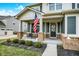 Charming front porch with brick columns, seating, and a welcoming entrance at 10237 Sand Run Ln, Fortville, IN 46040