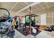 Well-organized garage with exercise equipment, bike storage, and ample space, ideal for fitness and outdoor enthusiasts at 10237 Sand Run Ln, Fortville, IN 46040