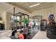 Garage setup with weight rack and storage at 10237 Sand Run Ln, Fortville, IN 46040