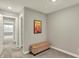 Cozy hallway to bedroom is carpeted with neutral paint, and features a storage bench at 10237 Sand Run Ln, Fortville, IN 46040