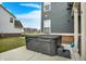 Hot tub on concrete pad with steps, next to house with gray horizontal siding at 10237 Sand Run Ln, Fortville, IN 46040