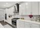 This spacious kitchen features white cabinets, stainless steel appliances, and quartz countertops at 10237 Sand Run Ln, Fortville, IN 46040