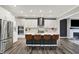 Bright kitchen with a center island, seating, stainless steel appliances, and views of the fireplace at 10237 Sand Run Ln, Fortville, IN 46040