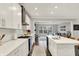 Modern kitchen with stainless steel appliances, island, and an open view into the cozy living room at 10237 Sand Run Ln, Fortville, IN 46040
