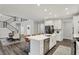 Open-concept kitchen and dining area featuring an island with seating, stainless appliances and modern finishes at 10237 Sand Run Ln, Fortville, IN 46040