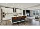 Modern kitchen with stainless steel appliances, white cabinets, a center island, and open sightlines to the living room at 10237 Sand Run Ln, Fortville, IN 46040