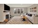 Stylish living room with a fireplace, large windows, and a comfortable sectional sofa at 10237 Sand Run Ln, Fortville, IN 46040