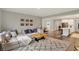 Spacious living room with a cozy sectional sofa, natural light, and an open layout into the kitchen at 10237 Sand Run Ln, Fortville, IN 46040