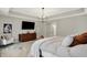 Bright primary bedroom offers tray ceiling, contemporary dresser, and a cozy chair at 10237 Sand Run Ln, Fortville, IN 46040