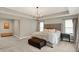 Bright main bedroom features neutral paint, tray ceiling, and modern light fixture at 10237 Sand Run Ln, Fortville, IN 46040