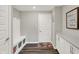 A well-organized mud room features a built-in bench with storage and a neutral color palette for a clean and functional space at 10237 Sand Run Ln, Fortville, IN 46040