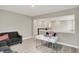 A versatile open office area includes a modern desk, comfortable sofa, and a view to the stairway for a well-connected space at 10237 Sand Run Ln, Fortville, IN 46040