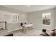 An airy office space offers a comfortable seating area, desk, and natural light, perfect for a productive work environment at 10237 Sand Run Ln, Fortville, IN 46040