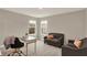 A cozy home office area features a gray sofa, desk, and natural light, ideal for a productive work environment at 10237 Sand Run Ln, Fortville, IN 46040