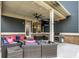 Covered patio with comfortable seating, outdoor TV, and barbecue grill at 10237 Sand Run Ln, Fortville, IN 46040