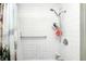 Bathroom stall featuring a shower head, shower control and a plastic shelving unit at 110 E Hendricks St, Shelbyville, IN 46176