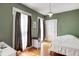 Cozy bedroom with hardwood floors, neutral walls and large windows at 110 E Hendricks St, Shelbyville, IN 46176
