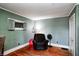 Bedroom featuring hard wood floors, gray walls, and a recliner and ball, with natural light from a window at 110 E Hendricks St, Shelbyville, IN 46176