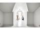 Attic bedroom with white walls, wood floors, and natural light from a dormer window at 110 E Hendricks St, Shelbyville, IN 46176