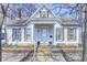 Charming home featuring a cozy front porch, colorful flower boxes, and a well-kept lawn, inviting and full of character at 110 E Hendricks St, Shelbyville, IN 46176
