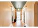 Bright hallway with gleaming hardwood floors and decorative molding throughout the home at 110 E Hendricks St, Shelbyville, IN 46176