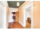 Hallway featuring hardwood floors, white trim, and neutral walls at 110 E Hendricks St, Shelbyville, IN 46176