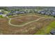 Scenic high angle aerial image showing neighborhood homes next to a pond surrounded by vegetation at 11598 Platt St, Noblesville, IN 46060