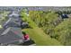 Aerial view of the home's dark shingles, deck with a red umbrella, and adjacent greenery and landscaping at 11598 Platt St, Noblesville, IN 46060