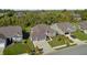 Aerial view showcasing the brick exterior, two-car garage, and beautifully landscaped yard of the home at 11598 Platt St, Noblesville, IN 46060