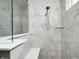 Bathroom shower showcasing light gray tiling, a shower head, and a clear glass shower door at 11598 Platt St, Noblesville, IN 46060