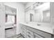Bathroom with dual sinks, modern fixtures, and a view into the bedroom at 11598 Platt St, Noblesville, IN 46060