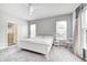 Spacious bedroom featuring a large bed, a ceiling fan, and natural light at 11598 Platt St, Noblesville, IN 46060