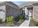 Charming brick home with manicured landscaping, leading to a welcoming front entrance with a red wreath at 11598 Platt St, Noblesville, IN 46060